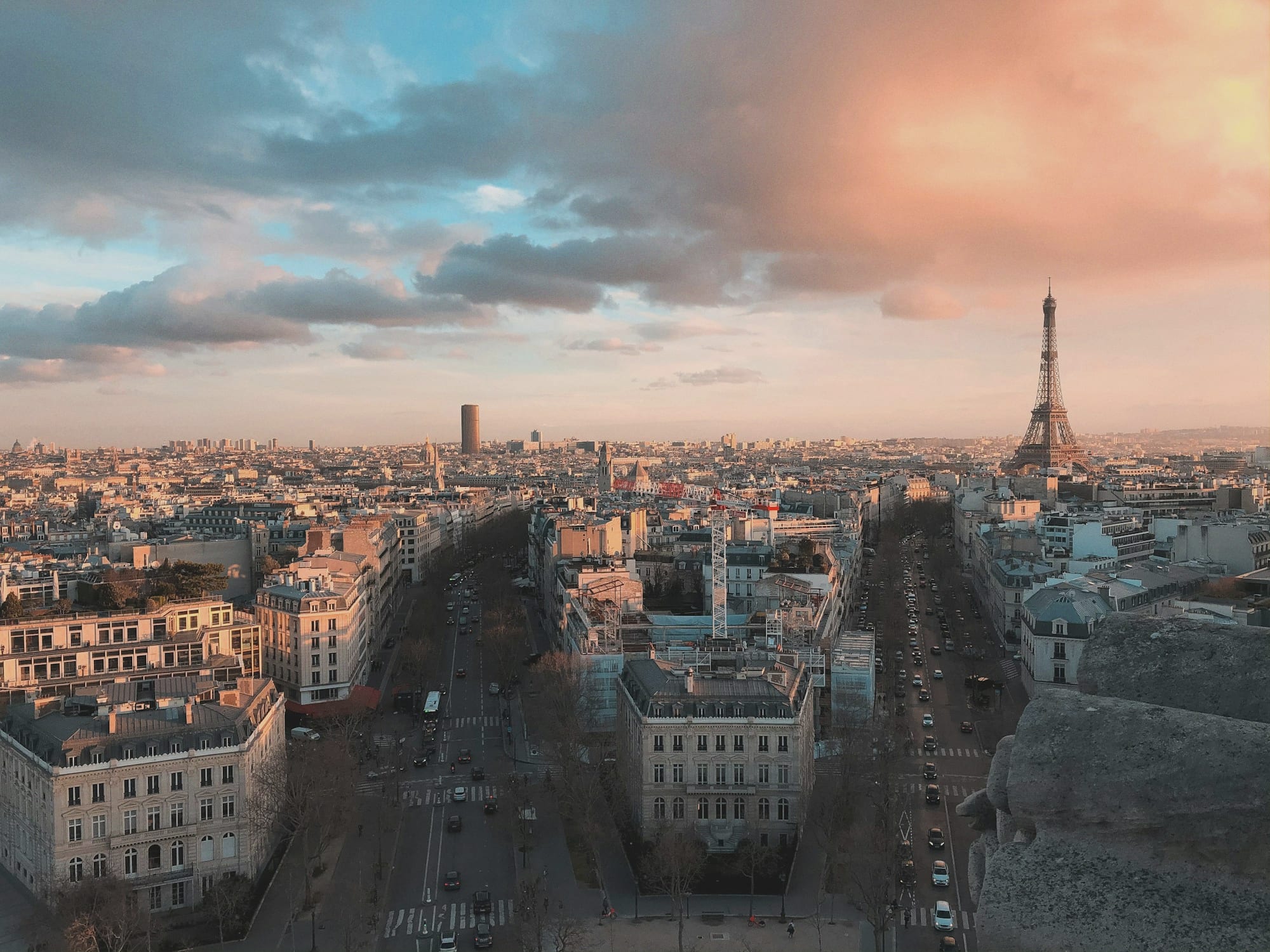The rooftops of Paris under a low evening sun.