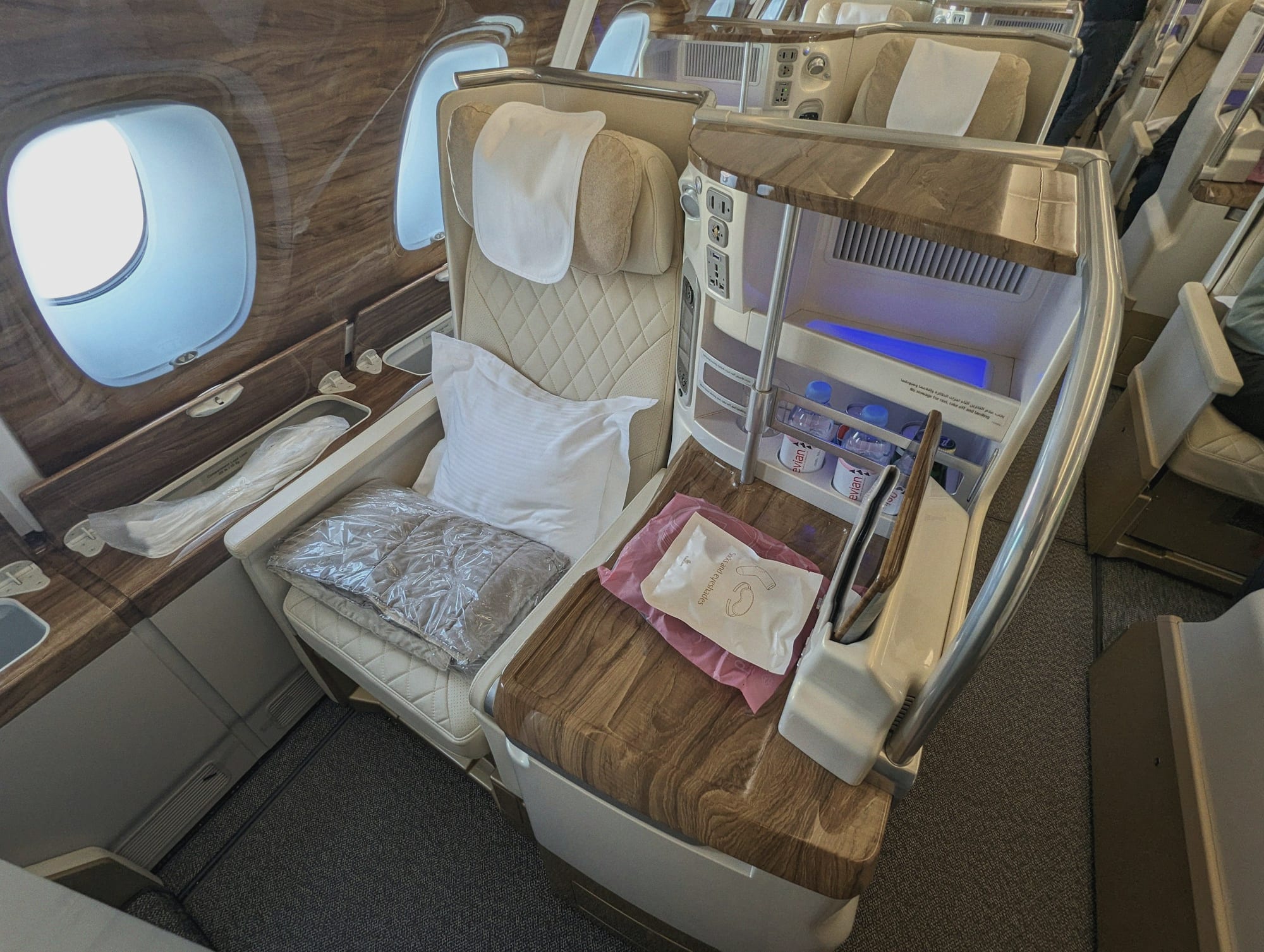A private suite cabin with a flat bed and a writing desk.